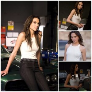 Gal Gadot Radiates Effortless Cool in Stylish Pose: Tight Jeans and Off-the-Shoulder White Tank Top Elegance