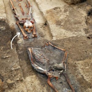 Uncovering the Enigmatic "Vampire" Graves: Skulls Interred Between the Legs