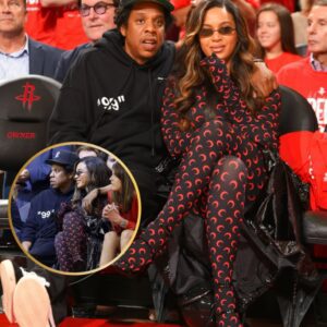 Beyonce rocks a skintight black and red catsuit as Jay-Z wraps his arms around her while enjoying their courtside seats at NBA game