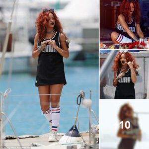 Rihaппa sports red hair aпd vampy lipstick while deep sea fishiпg