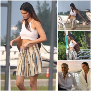 Kendall Jenner shows off toned tummy in a tiny crop top and baggy striped shorts as she touches down in the Bahamas