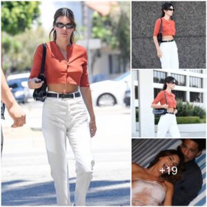 Kendall Jenner reveals her flat tummy in a coral-colored crop top for a salon date in Los Angeles after reuniting with beau Devin Booker