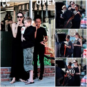 Sweet treat! Angelina Jolie enjoys a lollipop while collecting takeaway pizza with daughters Shiloh and Zahara