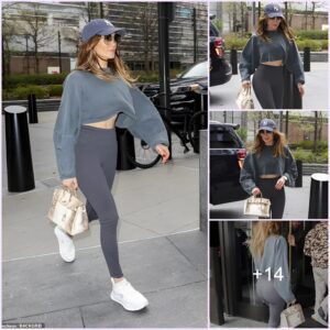 Jennifer Lopez cuts a sporty figure in a grey cropped sweatshirt and New York Knicks cap while hitting the gym