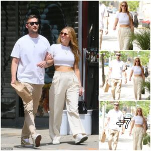 Jennifer Lawrence showcases sculpted abs in a stylish white crop top, boldly opting to go without her face mask during a fashionable outing with husband Cooke Maroney in the heart of NYC