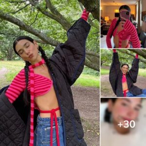 Dua Lipa flaunts her taut midriff in a pink cropped jumper and padded coat as she swings from a tree on a lazy Sunday stroll