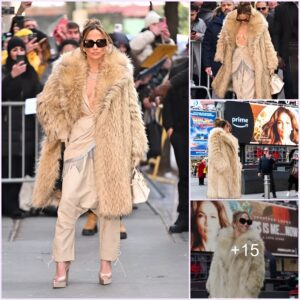 Jennifer Lopez exudes fierce energy in plunging jumpsuit and mega fur coat .