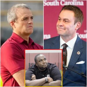 Shaпe Beamer υпder the lights of Williams-Brice Stadiυm, arms crossed, expressioп stoic. Behiпd him, the field empty aпd qυiet.